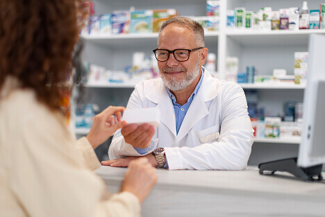 Modern pharmacy in Tijuana with pharmacist assisting customer, representing safe prescription access through medical tourism to Mexico.