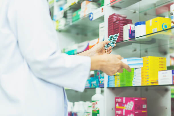 Patient outside pharmacy in Tijuana showing affordable Stelara cost per month compared to U.S. treatment prices.