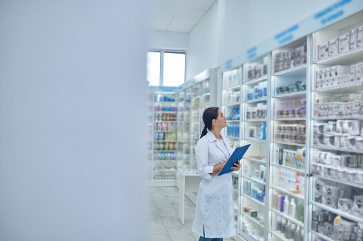 Interior of licensed pharmacy in Tijuana with pharmacist helping patients, part of medical tourism process.