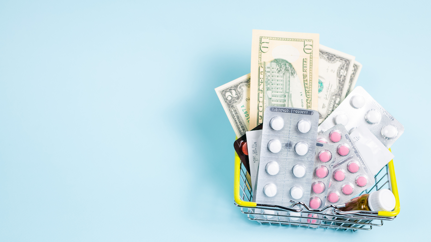 Prescription medications and U.S. dollars in a shopping basket, representing prescription savings